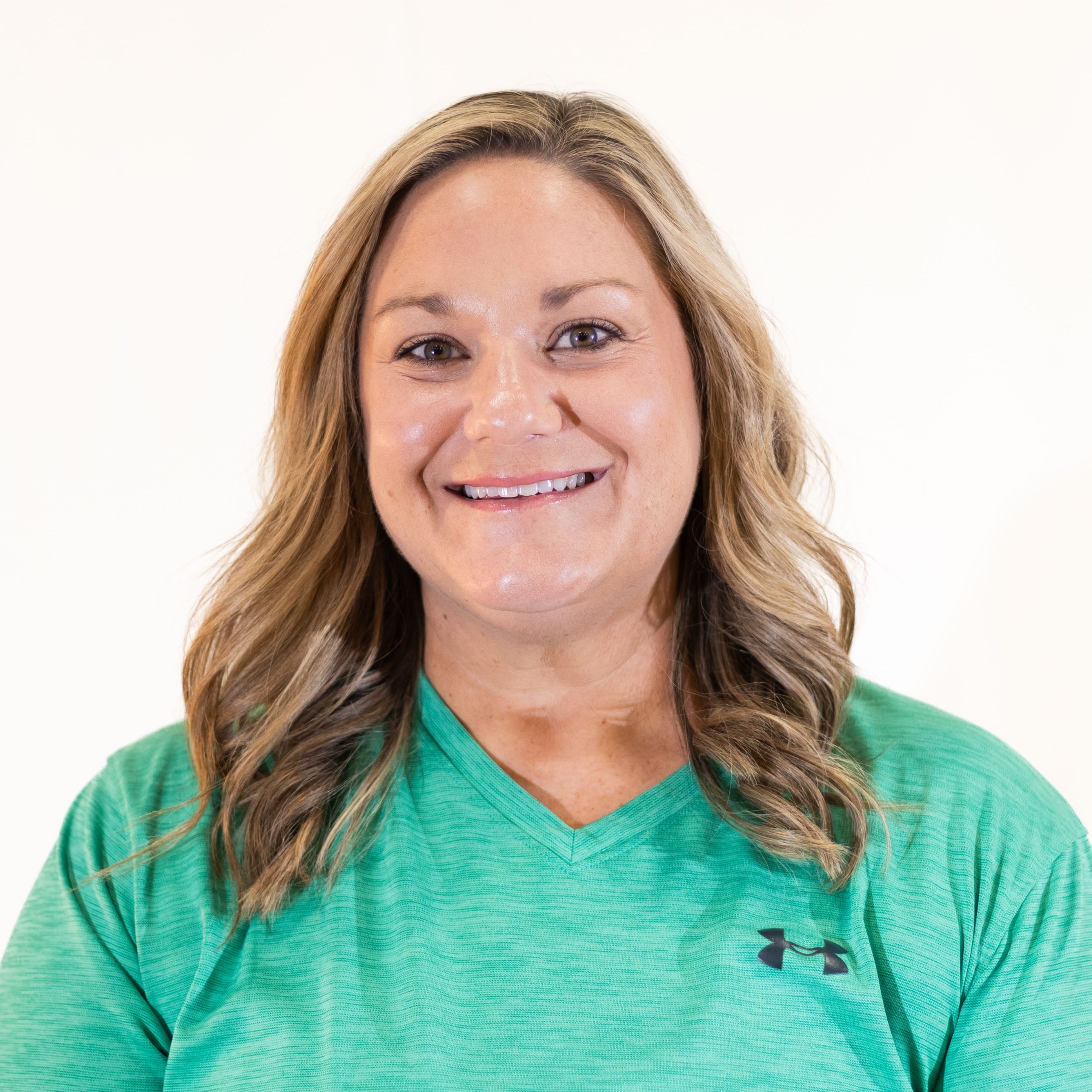woman smiling in teal shirt