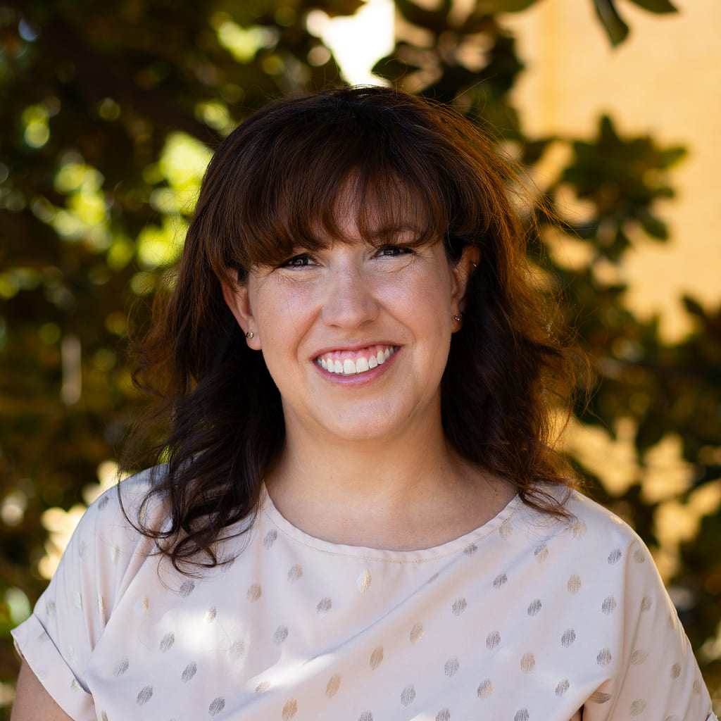 Smiling woman in a white t-shirts with dotted print
